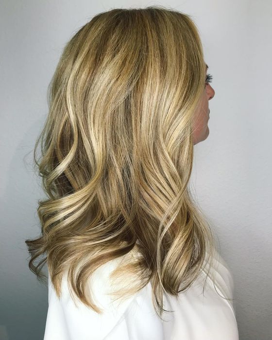 Shoulder-length honey blonde hair with loose waves, seen in profile