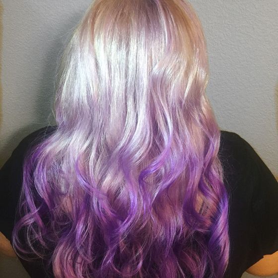 Long hair fading from pale silver-blonde to lavender and violet curled ends