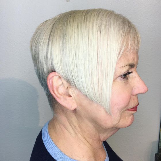 A short platinum blonde cut, longer at the front and cropped close at the nape, in profile